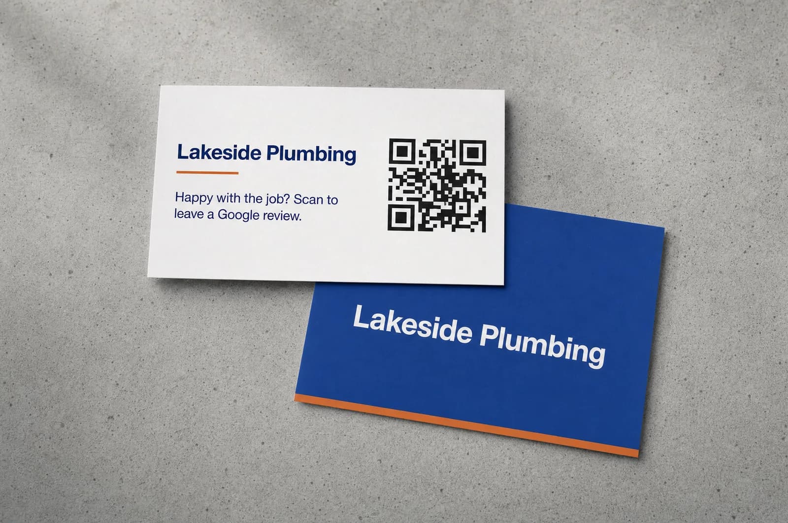 Front and back of a business card with a QR code, lying on a grey surface